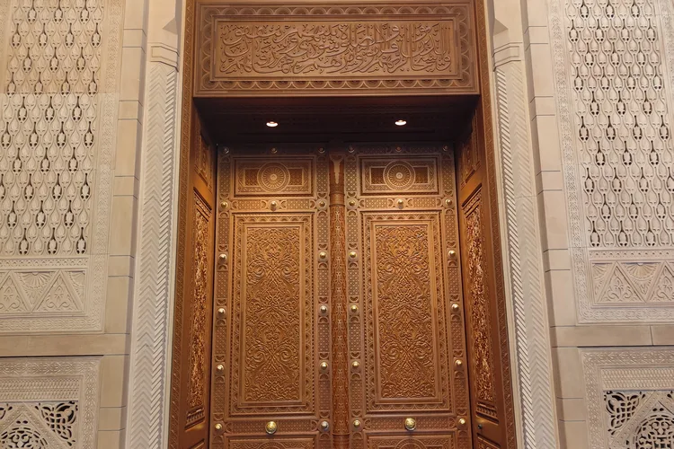Ornate wooden door at Sultan Qaboos Grand Mosque in Muscat, Oman.