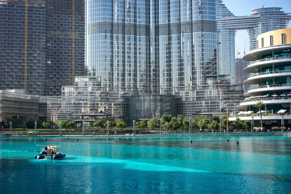 View of the Dubai skyline with Burj Khalifa and a nearby water feature.