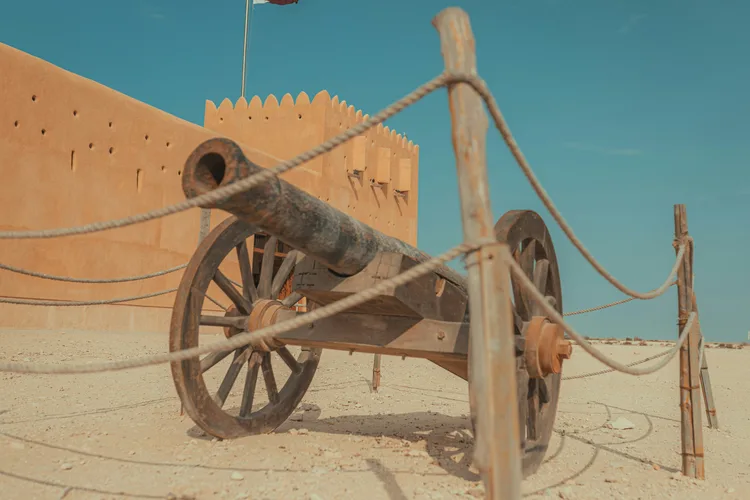 Historical cannon displayed at Al Zubarah Fort in Qatar.