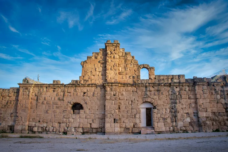 Ancient ruins in Jerash, Jordan, against a blue sky