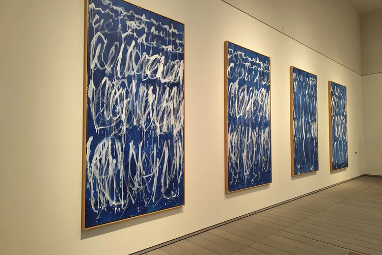 Modern art paintings in blue and white on display at Louvre Abu Dhabi.