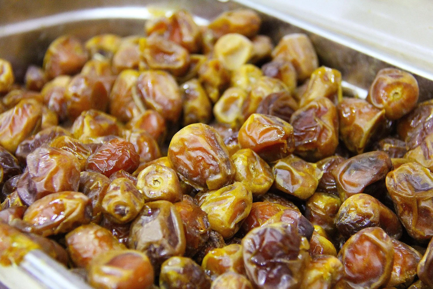 Close-up of a tray of Omani dates, a popular traditional dessert.