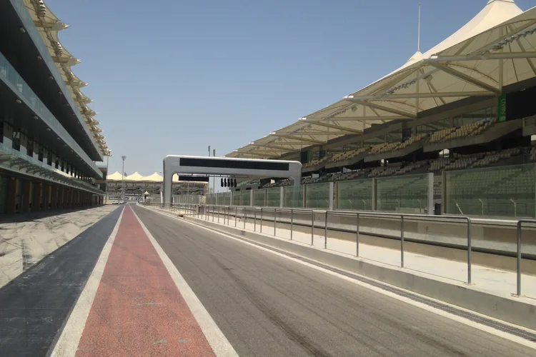 Empty track at Yas Marina Circuit, Abu Dhabi, under clear skies.