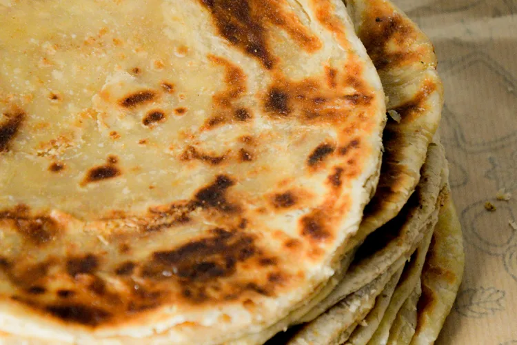 Closeup of a stack of traditional Omani bread displaying its texture and color.