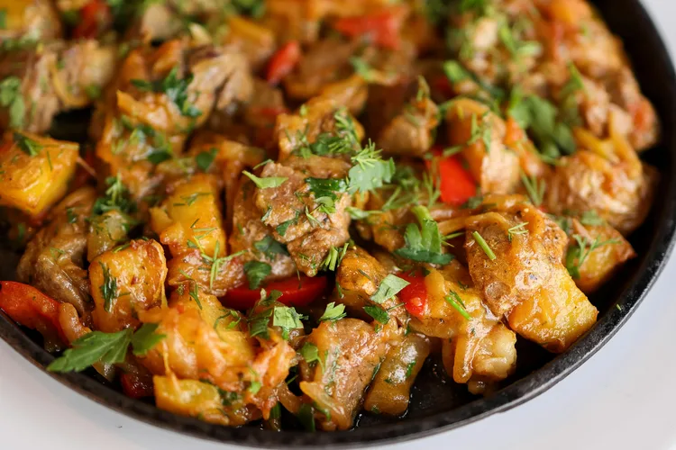 Traditional Omani camel meat stew garnished with herbs.