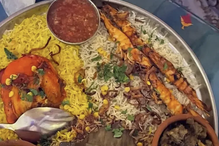 Traditional Omani dish with rice, shrimp, and chicken in Muscat restaurant.