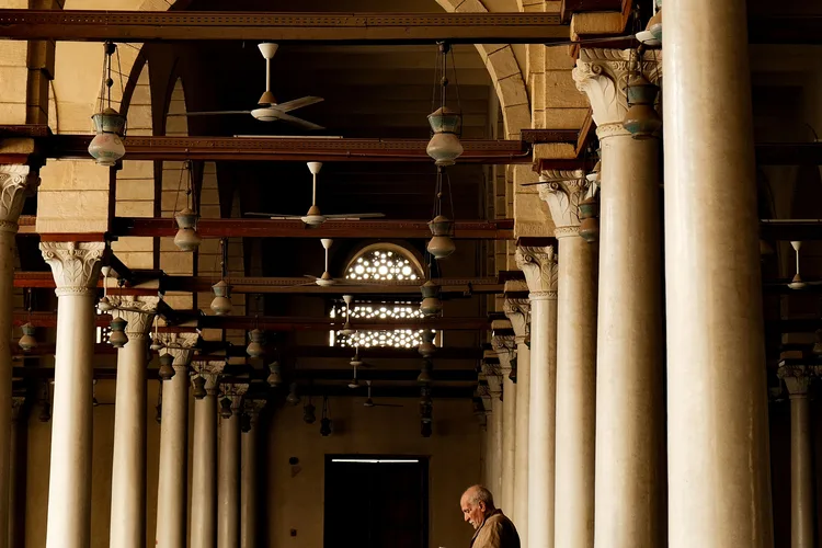Interior view of Amr Ibn al-As Mosque with tall stone columns.