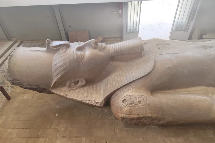 Colossal statue of Ramses II lying on its back in a museum in Mit Rahina, Egypt.