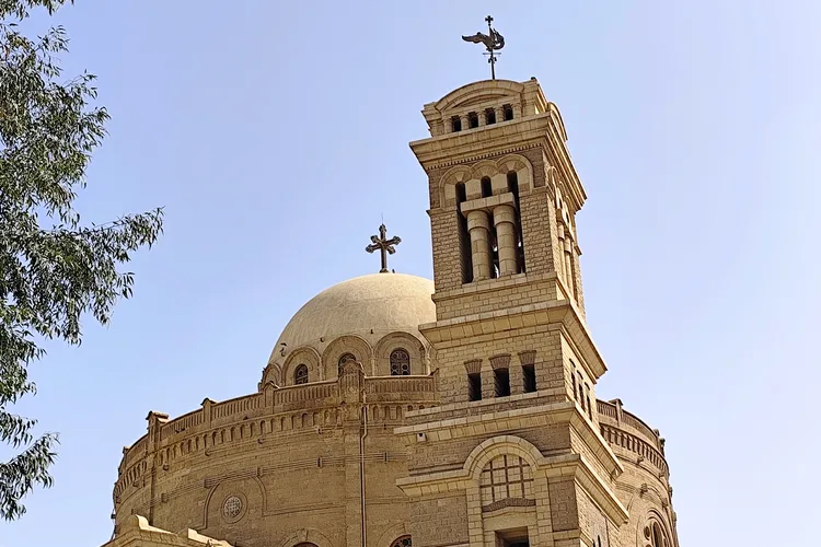 Coptic church dome in Cairo under a clear blue sky.