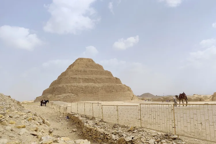 Saqqara Step Pyramid with sand and camels in view