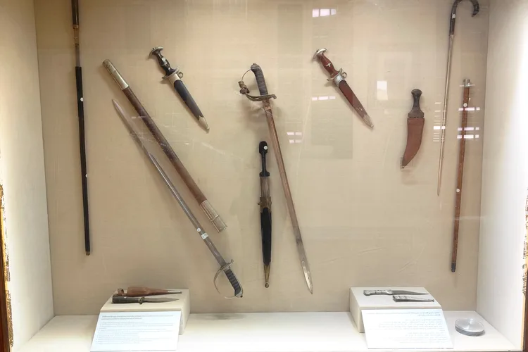 Collection of historical swords and daggers in Cairo Citadel Museum display.