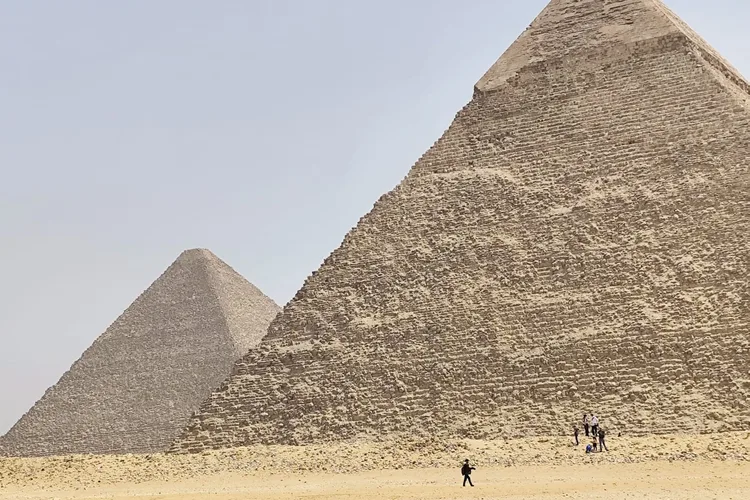 Two pyramids of Giza under a clear sky in Egypt.